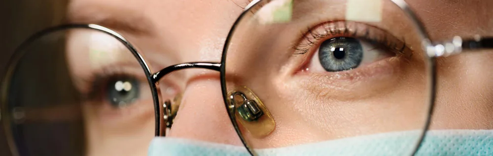 Close-up of patient through prescription eyewear at TK Optometry